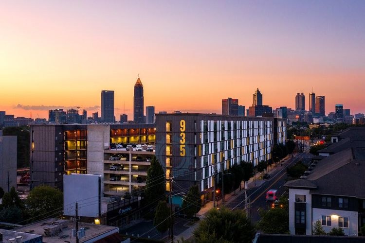 935M apartments at sunset with the Atlanta skyline